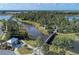 Aerial view of community with lake, walking bridge, and lush landscaping at 12654 Harney St, Venice, FL 34293