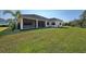 Home with covered patio and expansive grassy backyard at 12654 Harney St, Venice, FL 34293