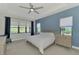 Spacious bedroom with large windows, ceiling fan, and ample closet space at 12654 Harney St, Venice, FL 34293