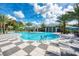 Resort-style pool with expansive sundeck and palm trees at 12654 Harney St, Venice, FL 34293