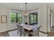 Elegant dining room with a live-edge table and globe chandelier at 12654 Harney St, Venice, FL 34293