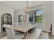 Bright dining room features a wood table, gray chairs, and large windows at 12654 Harney St, Venice, FL 34293