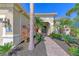 Front entry with brick walkway, tropical plants, and a welcoming atmosphere at 12654 Harney St, Venice, FL 34293