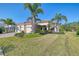 Single-Gathering home with tile roof, three-car garage, and lush landscaping at 12654 Harney St, Venice, FL 34293