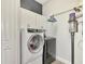 Bright laundry room features white cabinets, washer, and dryer at 12654 Harney St, Venice, FL 34293