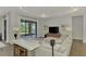 Light-filled living room featuring a sectional sofa and built-in media console at 12654 Harney St, Venice, FL 34293