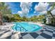 Resort-style pool with a checkered patio and plenty of lounge chairs at 12654 Harney St, Venice, FL 34293