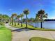 Scenic walkway along the lake with palm trees at 12654 Harney St, Venice, FL 34293