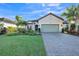 Single-story home with landscaped yard, paver driveway, and two-car garage at 12826 Sorrento Way, Bradenton, FL 34211