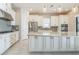 Modern kitchen with white cabinets, stainless steel appliances, and granite island at 12826 Sorrento Way, Bradenton, FL 34211