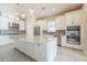 Modern kitchen with white cabinets, stainless steel appliances, and granite island at 12826 Sorrento Way, Bradenton, FL 34211