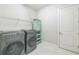 Convenient laundry room with washer, dryer, and storage shelving at 12826 Sorrento Way, Bradenton, FL 34211