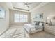 Large main bedroom with carpeted floors, a ceiling fan and large windows at 12826 Sorrento Way, Bradenton, FL 34211