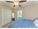 Bedroom with a queen bed, ceiling fan, and double door closet at 13262 Jeter Creek Dr, Riverview, FL 33579