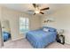 Bright bedroom with a queen bed, ceiling fan, and large window at 13262 Jeter Creek Dr, Riverview, FL 33579