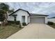 White house with gray garage door and small front yard at 13262 Jeter Creek Dr, Riverview, FL 33579