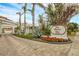 Welcoming entrance to The Players Club, featuring a brick road and landscaping at 1465 Gulf Of Mexico Dr # 402, Longboat Key, FL 34228