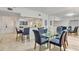 Elegant dining room with glass table and seating for six at 1465 Gulf Of Mexico Dr # 402, Longboat Key, FL 34228