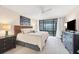 Main bedroom with king bed, water view, and ceiling fan at 1465 Gulf Of Mexico Dr # 402, Longboat Key, FL 34228