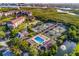 Aerial view showing tennis courts, pool, and landscaping at 1479 Landings Cir # 41, Sarasota, FL 34231