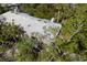 Aerial view of a house with a gray roof, surrounded by lush green trees at 1479 Landings Cir # 41, Sarasota, FL 34231