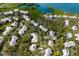 Aerial view of waterfront homes with solar panels and lush surroundings at 1479 Landings Cir # 41, Sarasota, FL 34231