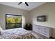 Main bedroom with large windows, balcony access and TV at 1479 Landings Cir # 41, Sarasota, FL 34231