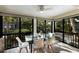 Bright sunroom dining area with glass table and chairs at 1479 Landings Cir # 41, Sarasota, FL 34231