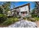 Two-story townhome with gray siding, red door, and a stone walkway at 1479 Landings Cir # 41, Sarasota, FL 34231