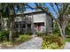 Two-story home with gray siding, red door, and landscaped yard at 1479 Landings Cir # 41, Sarasota, FL 34231