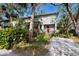 Two-story home with gray siding, red door, and landscaped yard at 1479 Landings Cir # 41, Sarasota, FL 34231