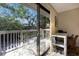 Home office with balcony access and view of lush trees at 1479 Landings Cir # 41, Sarasota, FL 34231