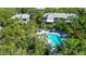 Aerial view of community pool area with surrounding lush landscaping at 1479 Landings Cir # 41, Sarasota, FL 34231