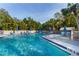 Inviting community pool with ample lounge chairs and umbrellas at 1479 Landings Cir # 41, Sarasota, FL 34231