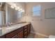 Bathroom with granite countertops, double sinks, and a large mirror at 14901 17Th E Ave, Bradenton, FL 34212