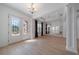 Elegant dining room with hardwood floors, chandelier, and mirrored wall at 14901 17Th E Ave, Bradenton, FL 34212