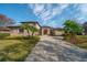 Two-story home with palm trees and a long driveway at 14901 17Th E Ave, Bradenton, FL 34212