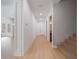 Bright hallway with light wood floors and white walls at 14901 17Th E Ave, Bradenton, FL 34212