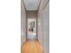 Light hallway with light wood floors and access to bathroom at 14901 17Th E Ave, Bradenton, FL 34212