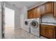 Laundry room with washer, dryer, and wood cabinets at 14901 17Th E Ave, Bradenton, FL 34212