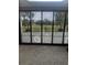 View of backyard through a sliding glass door at 15986 Cutting Horse Trl, Myakka City, FL 34251