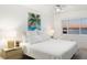 Main bedroom with a king-size bed, ceiling fan, and waterfront view at 1602 Stickney Point Rd # 1602-301, Sarasota, FL 34231