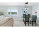 Modern dining area with water views and stylish light fixtures at 1602 Stickney Point Rd # 1602-301, Sarasota, FL 34231