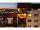 Night view of condo building with lighted balconies and palm trees at 1602 Stickney Point Rd # 1602-301, Sarasota, FL 34231