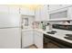 White kitchen with stainless steel appliances and a view from the window at 1602 Stickney Point Rd # 1602-301, Sarasota, FL 34231