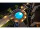 Night view of circular pool surrounded by lounge chairs and patio lights at 1602 Stickney Point Rd # 1602-301, Sarasota, FL 34231