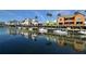 Waterfront homes with boats and reflections at 1602 Stickney Point Rd # 1602-301, Sarasota, FL 34231