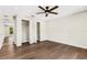 Hardwood floor bedroom with ceiling fan and access to hallway at 1608 80Th Nw St, Bradenton, FL 34209