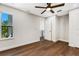 Spacious bedroom with hardwood floors, ceiling fan, and access to balcony at 1608 80Th Nw St, Bradenton, FL 34209