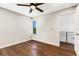 Bedroom with hardwood floors, ceiling fan and access to upper hallway at 1608 80Th Nw St, Bradenton, FL 34209